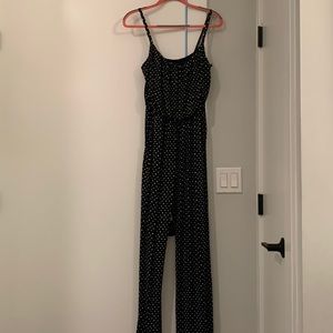 Black with white polka dot jumpsuit with pockets. Silky material and stretchy.
